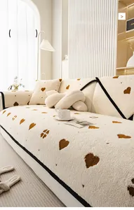 Detail view of thickened cream sofa cover with brown heart patterns and plush texture