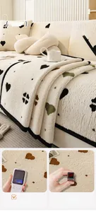 Detail of plush cream sofa cover with colorful heart patterns and soft texture
