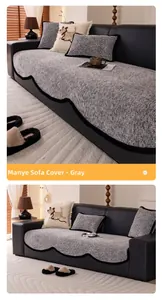 Close-up of grey chenille sofa cushion with black scalloped edge on leather sofa