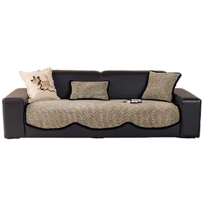 Chenille irregular sofa cover with heavy knit texture and wave trim on black leather couch