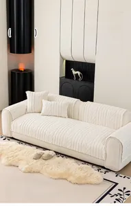 Detailed view of cream-colored fleece sofa cover with embossed leaf patterns