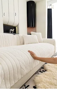 Detail of cream plush sofa cover showing thick embossed leaf pattern and soft fabric