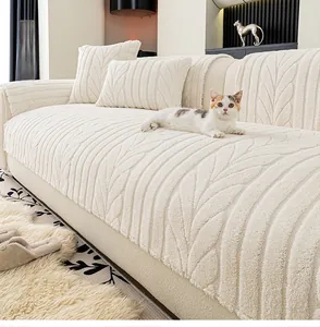 Detail of cream white plush sofa cover with leaf texture and matching pillow covers