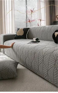 Detail of grey sofa cover featuring a 3D embossed leaf pattern in soft knit fabric