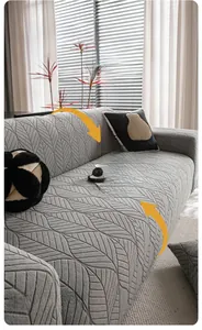 Detail of grey polar fleece sofa cover with 360-degree non-slip leaf texture fabric