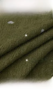 Detailed macro view of olive green thick velvet fabric with soft plush texture