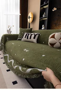 Detailed view of dark green chenille sofa throw featuring thick knit texture and tassels