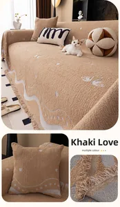 Detail of khaki plush sofa cover with white wavy jacquard patterns and tassel fringe