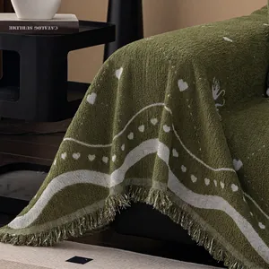 Thick dark green sofa throw blanket with heart patterns and fringe decorative tassels