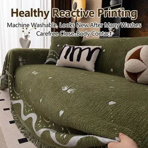 Thick dark green sofa throw blanket with white heart patterns and elegant fringe trim