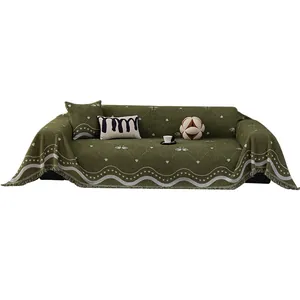 Thick dark green knit sofa blanket with white swan patterns and elegant fringe borders