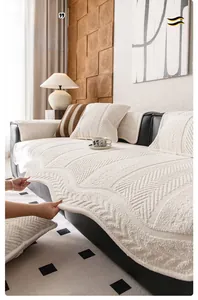 Detail view of cream-white chenille sofa cover featuring unique wavy edges and quilted texture