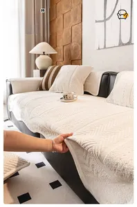 Close-up of cream chenille sofa cover with textured herringbone pattern on black leather