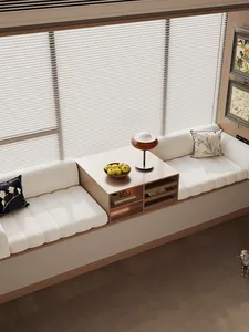 Detail of white striped teddy velvet bay window mat with cozy pillows and mushroom lamp