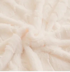 Close-up of plush rabbit faux fur sofa cover showing thick cream velvet texture and softness