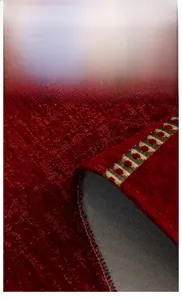 Detail of red Christmas chenille sofa cushion showing woven texture and durable edging
