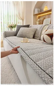 Detail of light grey bubble textured sofa cover with protective black edging