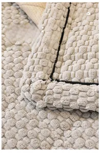 Detail of thickened corduroy sofa cover with bubble texture and black stitched edges