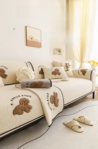 Close-up of thick teddy fleece sofa cushion with cute puppy embroidery and plush texture
