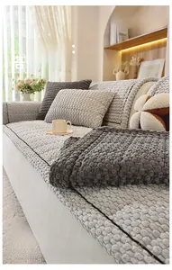 Detail of thick corduroy sofa cover set with 3D textured fabric and grey cushions
