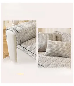 Close-up of thick corduroy sofa cushion with black piping and matching pillow detail