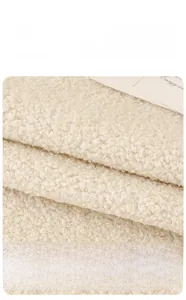 Close-up of thick beige teddy velvet sofa cover fabric with high-density texture