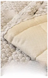 Detailed view of beige corduroy sofa cover featuring non-slip particle backing texture