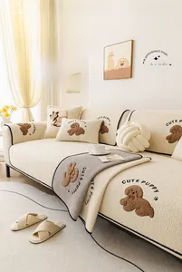 Detail of cream teddy fleece sofa cover with cute puppy embroidery and plush texture