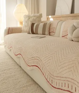 Detail of cream thickened lamb wool sofa cover with red wave pattern and herringbone quilting