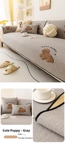 Detail of grey teddy velvet sofa cushion with cute puppy embroidery and soft texture