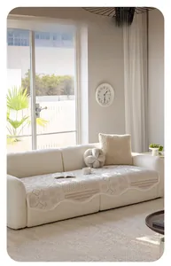 Close-up of cream velvet sofa cover featuring jacquard floral patterns and wavy edges