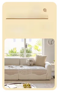 Detail of cream velvet sofa cover with diamond stitching and wavy scalloped edge