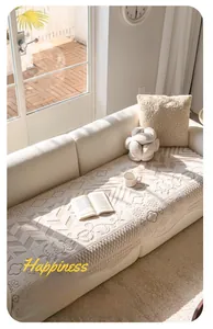 Detail of off-white velvet sofa cover featuring 3D quilted patterns and cozy pillows