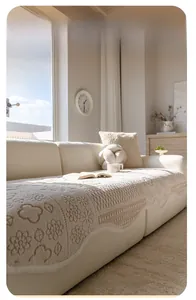 Exquisite cream sofa cover detail featuring 3D floral weave and elegant wavy edges