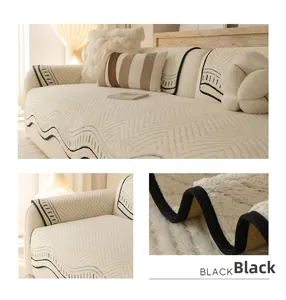 Detail of cream plush sofa cover with wave quilting and black wavy contrast edge