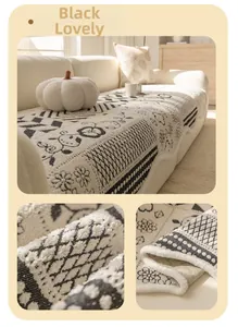 Detail of black and white plush sofa cover showing teddy bear and floral knit texture