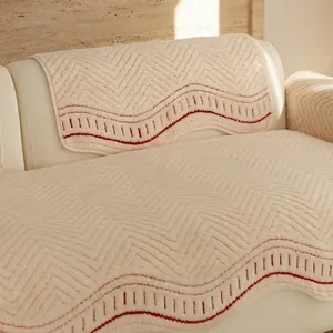 Creamy white irregular sofa cover with quilted wavy texture and red decorative stitching