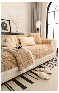 Detail of modern velvet sofa cover with feather texture and white pom-pom fringe trim