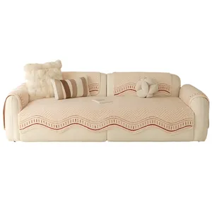 Cream scalloped quilted sofa cover set with herringbone texture and red stitching detail