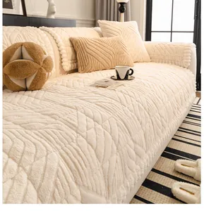 Close-up of quilted off-white plush sofa cover with wave lace edges and rhombic texture