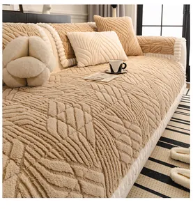 Close-up of thick plush sofa cushion with embossed leaf pattern and decorative pillows