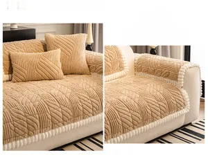 Close-up of khaki plush sofa cover with 3D feather texture and white pom-pom trim