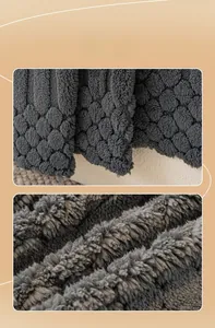 Macro detail of thick dark gray sofa cover showing wave texture and soft fleece material
