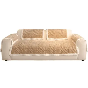 Modern camel quilted sofa cover with leaf patterns and white pom pom edge decor