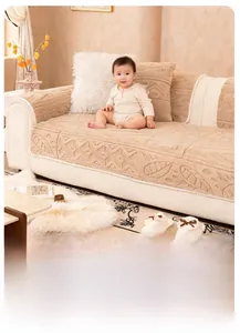 Detail of beige plush sofa cover with embossed leaf pattern and non-slip texture