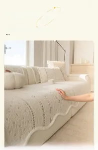 Detail of cream plush jacquard sofa cover with strawberry lettering and wavy edges