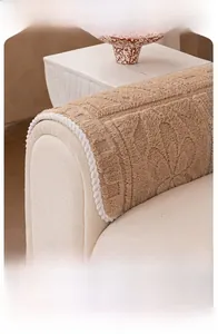 Close-up of camel plush sofa cover with floral texture and white wavy scalloped edges