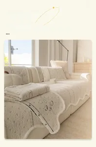Detail of cream plush sofa cover showing wavy edges and minimalist pattern texture