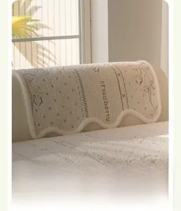 Plush cream sofa cover with strawberry motifs and elegant scalloped edge detail