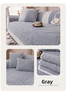 Detail of grey plush sofa cover with geometric embossed leaf patterns and thick texture